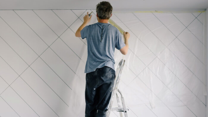 Renovation contractor installing feature wall on business premises